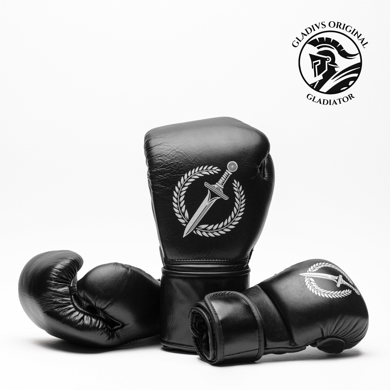Black boxing gloves with a logo on a white background, featuring the 'Gladius Gladiator' brand.