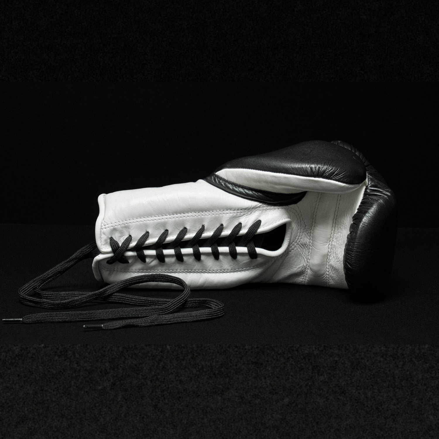 Black and white boxing glove on a black background.