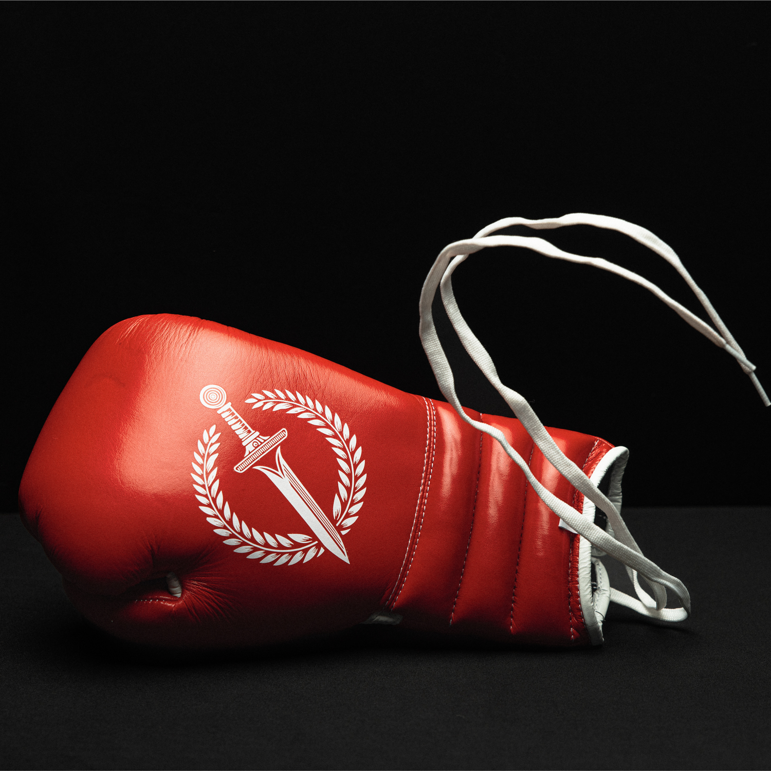 Red boxing glove with a white logo on a black background