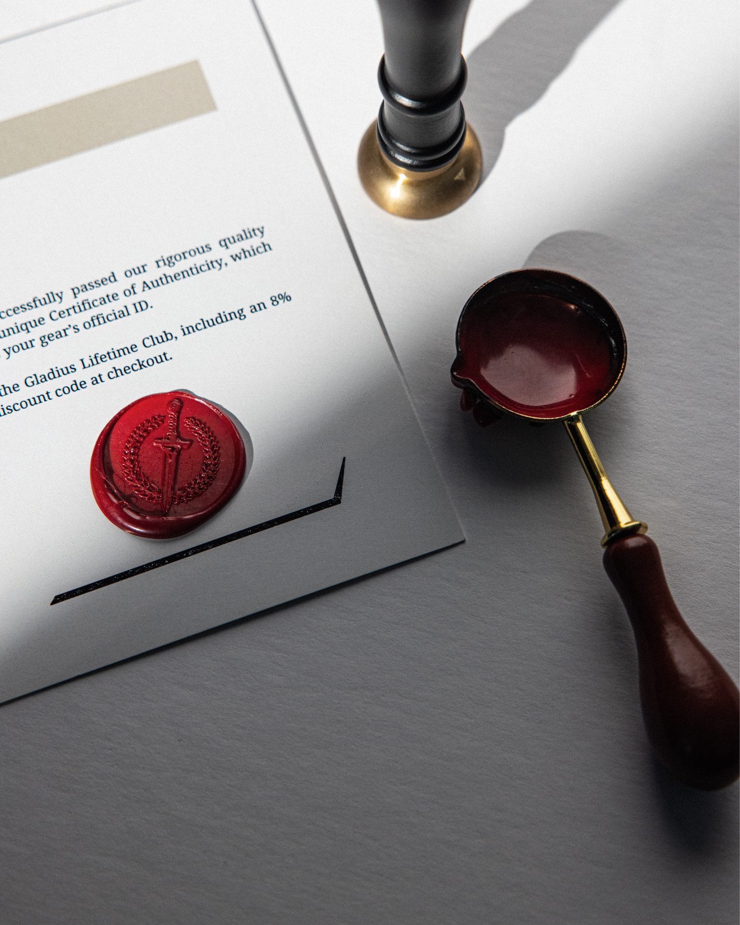 Wax seal and sealing tool on a document with a gray background.