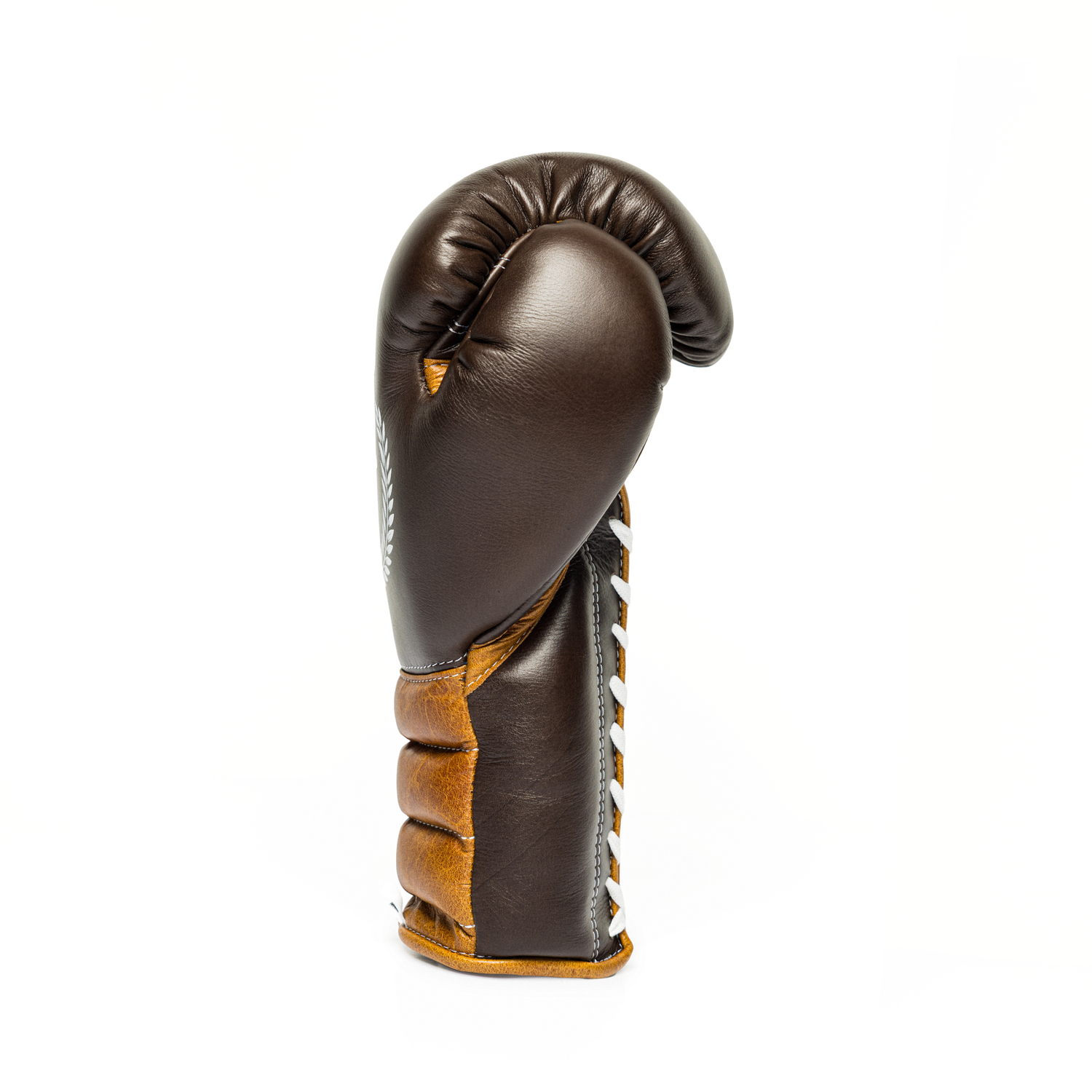 Sideway profile of a brown leather boxing glove on a white background.