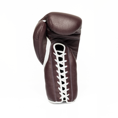 Burgundy boxing glove with laces on a white background.