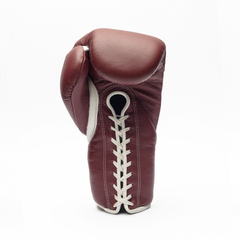 Maroon boxing glove with white laces on a white background.