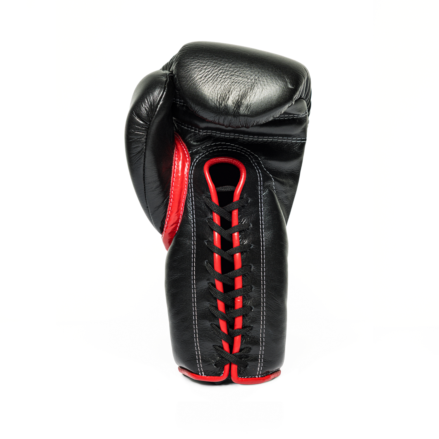 Black and red lace-up boxing glove on a white background.