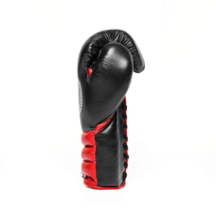 Sideway profile of a red and black lace-up boxing glove on a white background.