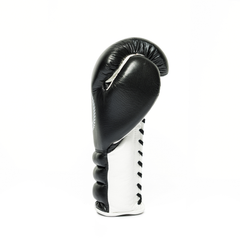 Sideways profile of a black and white boxing glove on a white background.