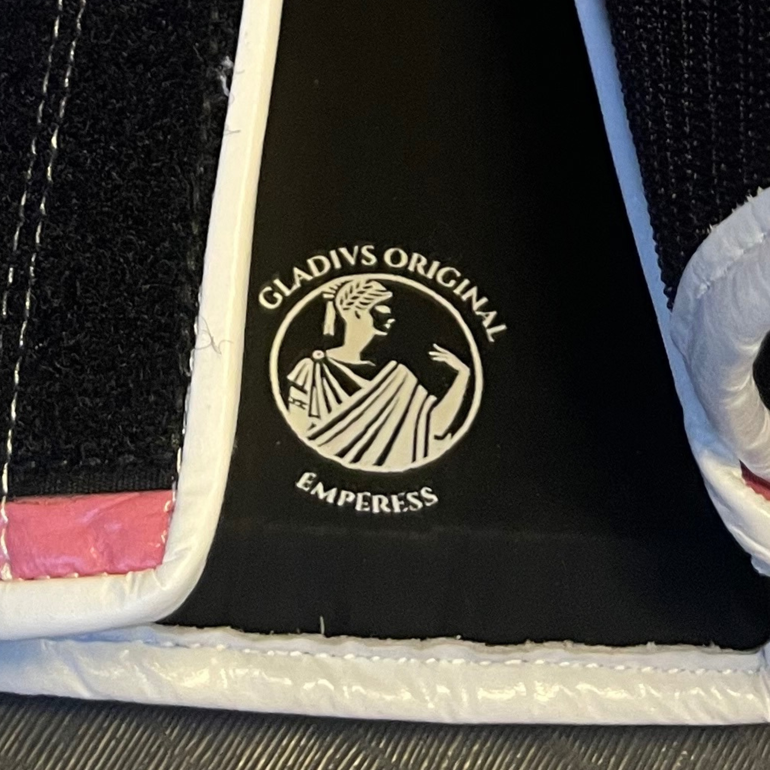 Close-up of a product with 'Gladius Original Empress' branding on a textured surface.